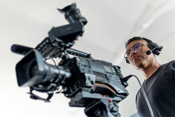 Male,Cameraman,Wearing,Headset,,Operating,A,Camera,For,Television,Broadcasting